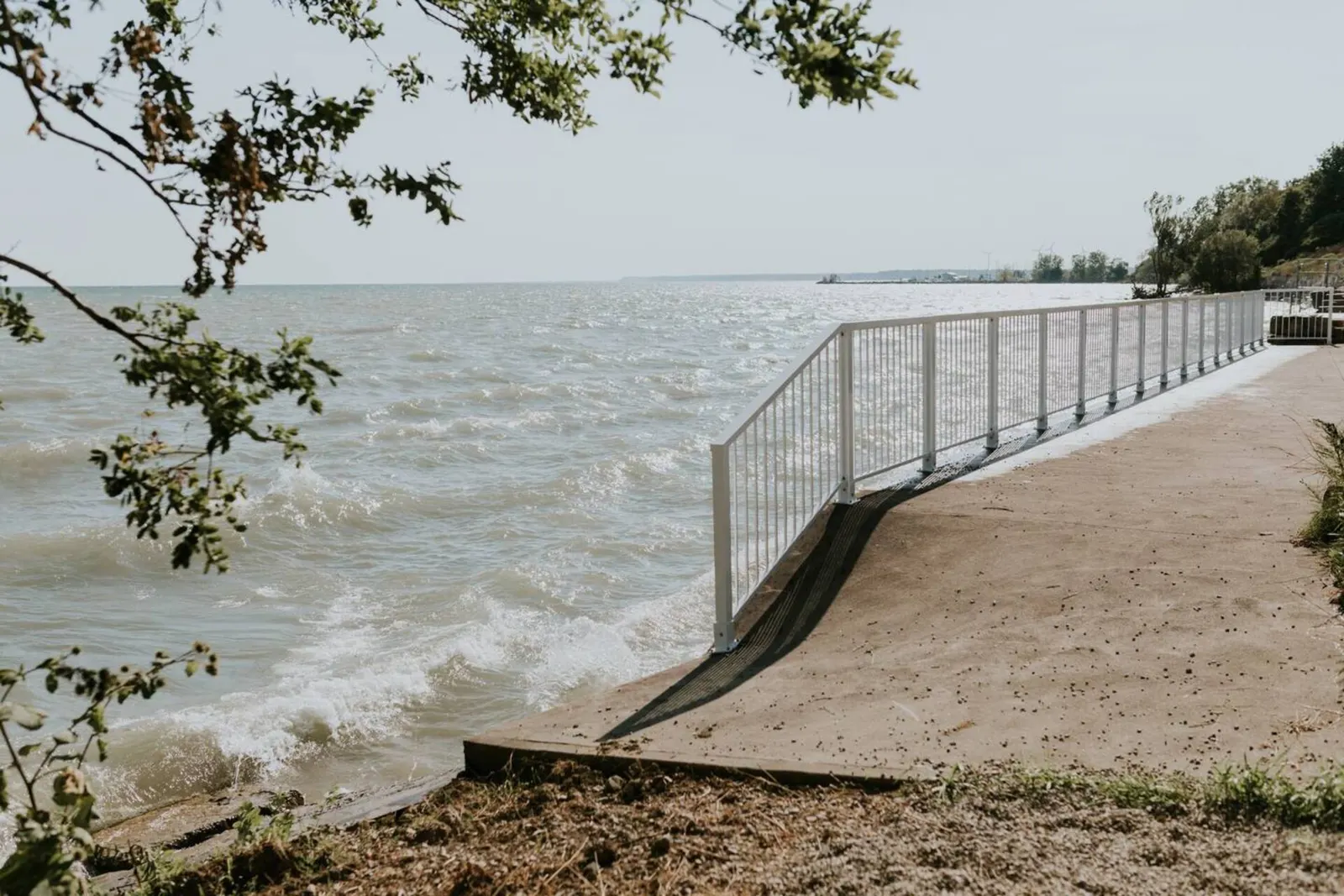 Concrete pad and steps down to the private beach