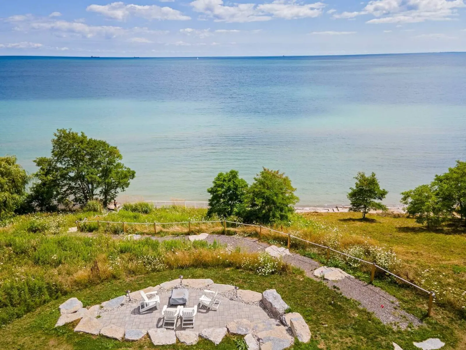Aerial view of Dover Lake House's lakefront fire pit and Lake Erie